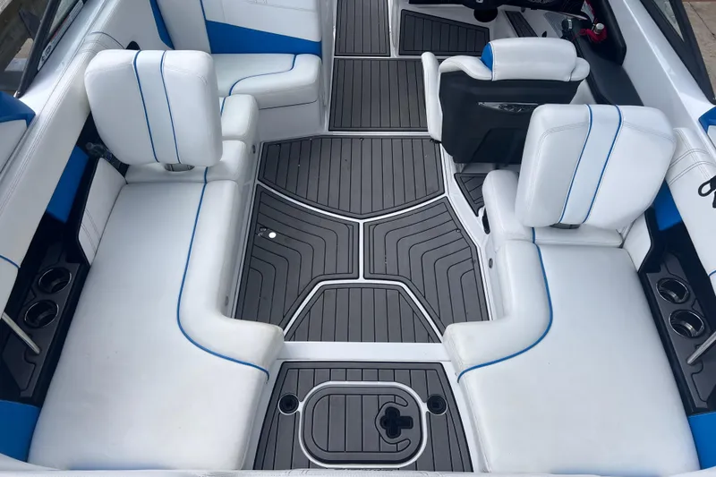 Slide: The Image of Interior of a 2016 Nautique Super Air Nautique 210 boat with white seating. - 22