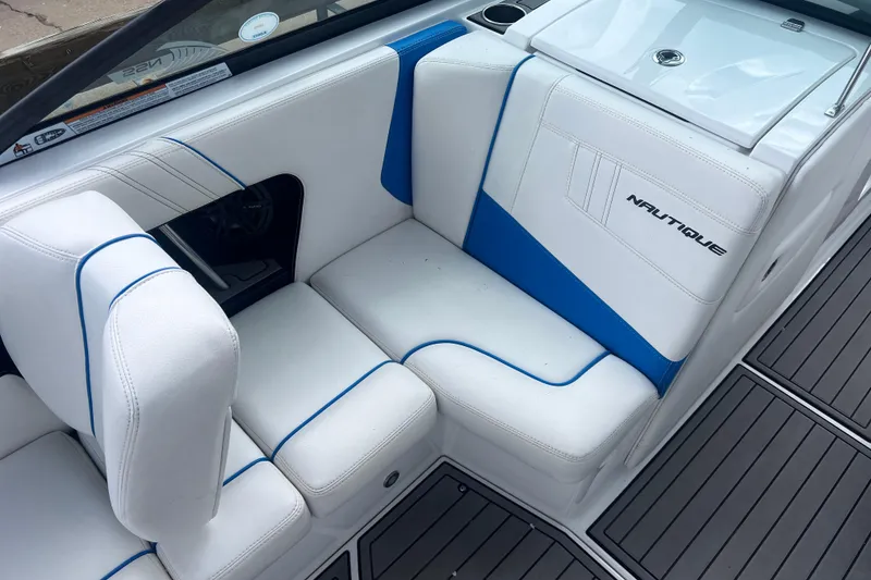 Slide: The Image of 2016 Nautique Super Air Nautique 210 interior with white and blue seating. - 26