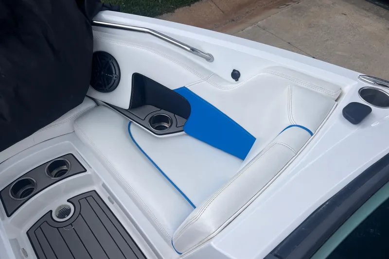 Slide: The Image of Interior of 2016 Nautique Super Air Nautique 210 boat with white seating and cup holders. - 28