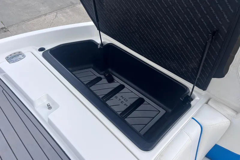 Slide: The Image of 2016 Nautique Super Air Nautique 210 storage compartment open. - 30