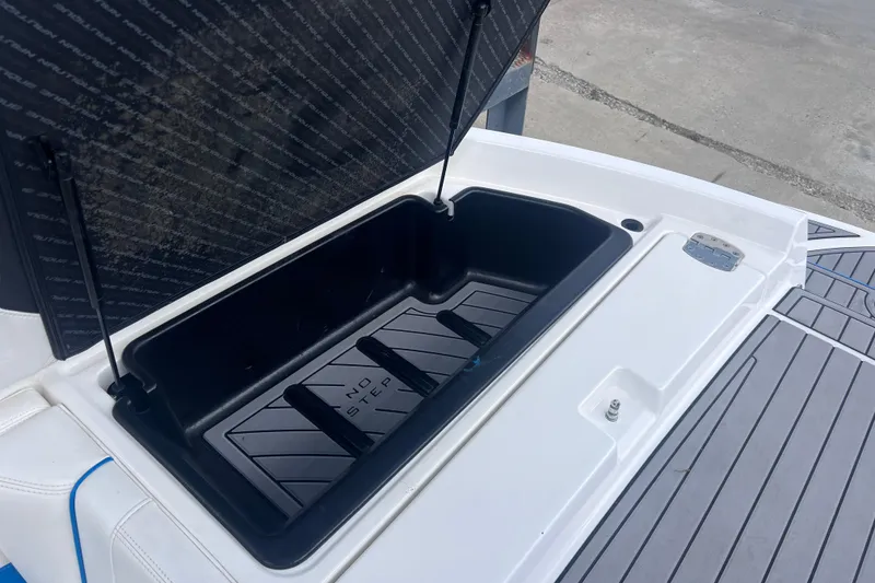Slide: The Image of Open storage compartment on 2016 Nautique Super Air Nautique 210 boat. - 31