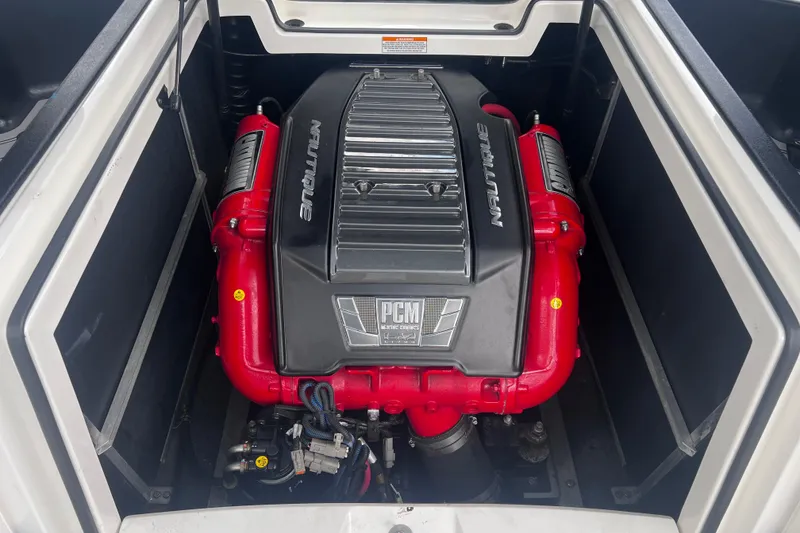 Slide: The Image of Engine of 2016 Nautique Super Air Nautique 210 with PCM branding, red and black components. - 32
