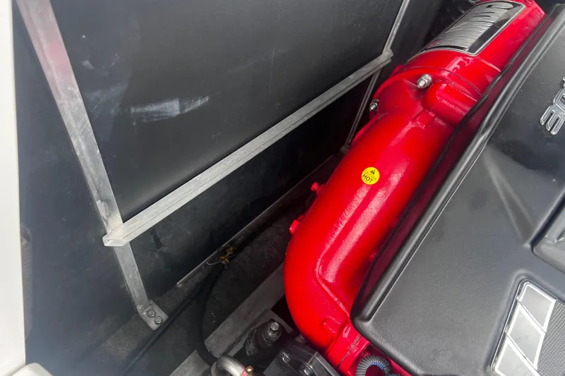 Slide: The Image of 2016 Nautique Super Air Nautique 210 engine compartment with red engine components. - 33