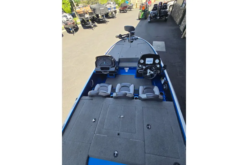 Slide: The Image of 2014 Nitro Z-7 boat interior with steering console and seating. - 2