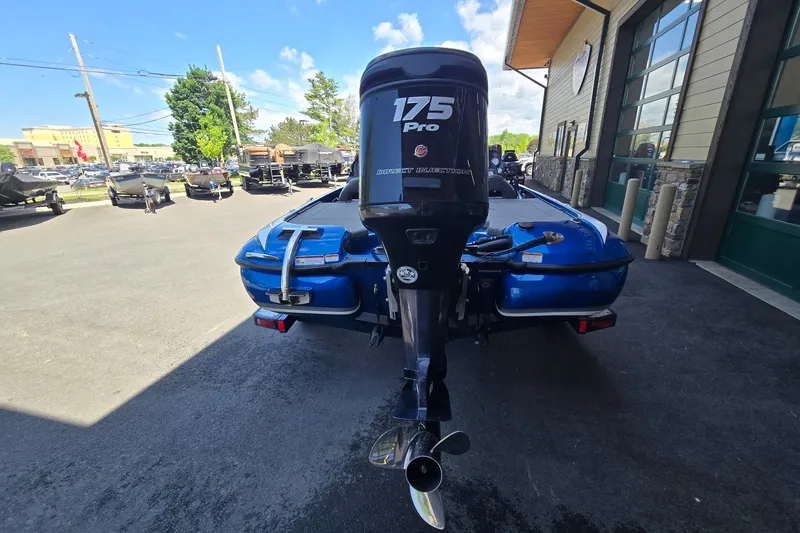 Slide: The Image of 2014 Nitro Z-7 boat with 175 Pro engine, parked outdoors near a building. - 6