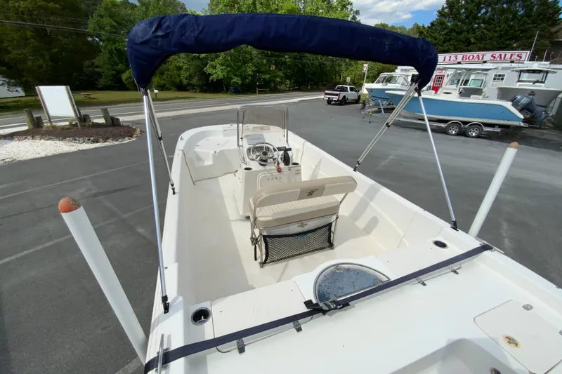 Slide: The Image of 2016 Carolina Skiff 198 DLV boat with canopy, parked at dealership. - 15