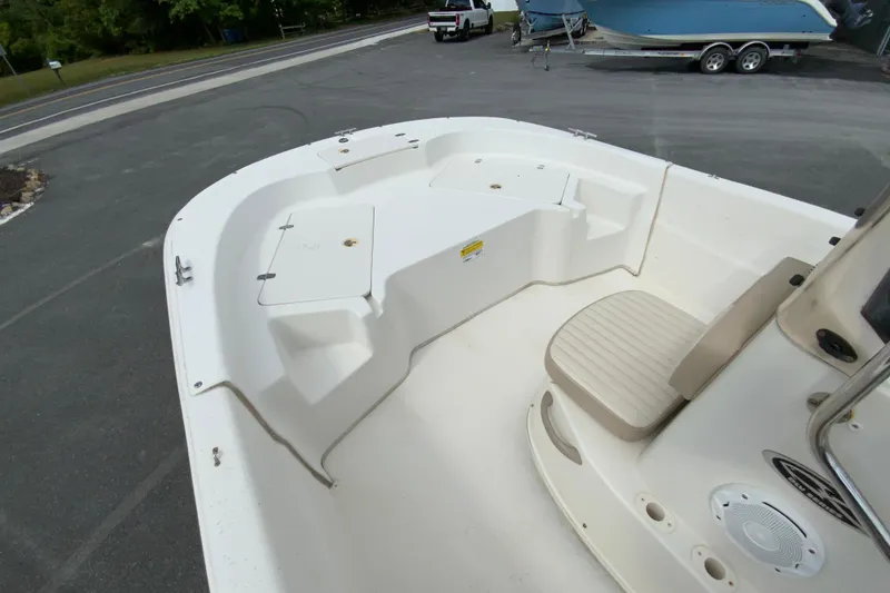 Slide: The Image of 2016 Carolina Skiff 198 DLV boat interior with seating and storage compartments. - 18