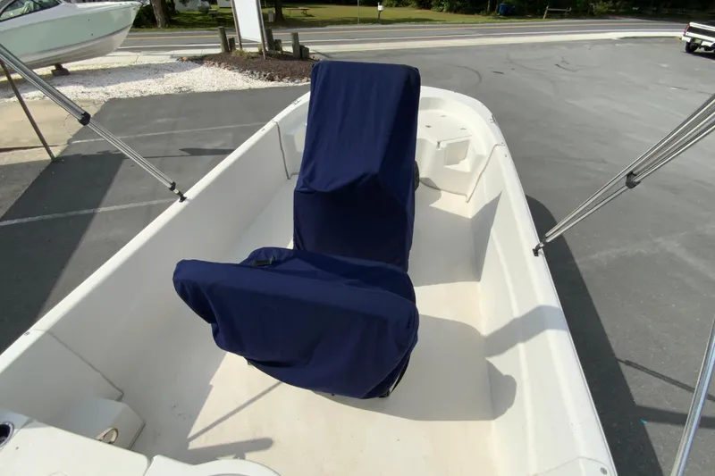 Slide: The Image of 2016 Carolina Skiff 198 DLV boat interior with covered seats and bimini top frame. - 3