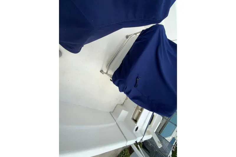 Slide: The Image of 2016 Carolina Skiff 198 DLV boat deck with blue protective covers. - 5