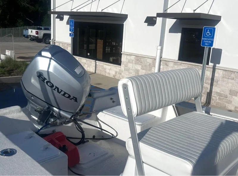 Slide: The Image of May-Craft 1900CC 2020 with Honda outboard motor, parked outside a building. - 11