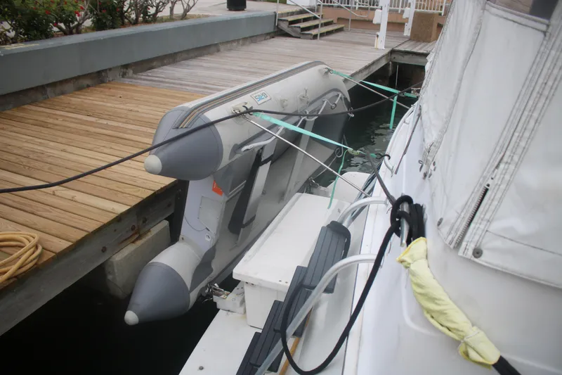 Slide: The Image of Inflatable dinghy secured on a 1998 Mainship 47 Motor Yacht at a dock. - 10