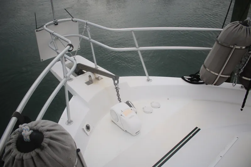 Slide: The Image of Bow of 1998 Mainship 47 Motor Yacht with anchor and fenders. - 11