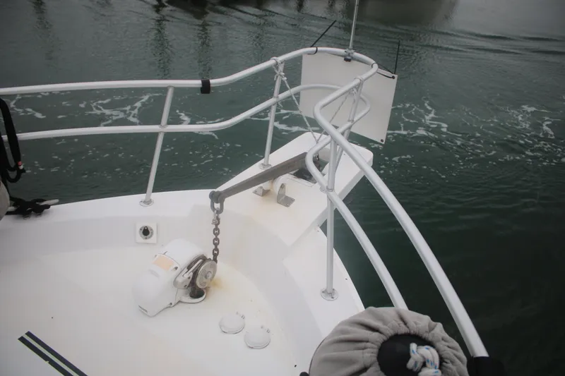 Slide: The Image of Bow of 1998 Mainship 47 Motor Yacht with anchor chain and railing. - 12