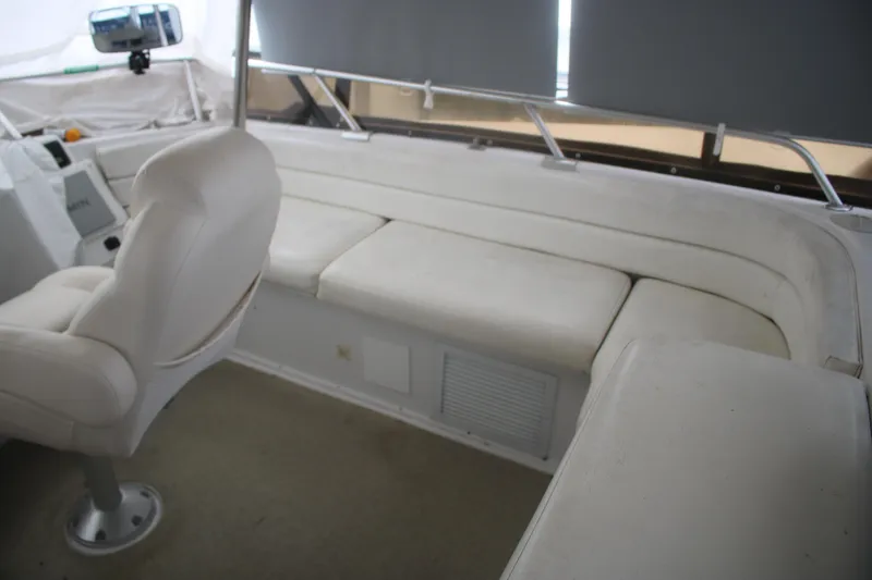 Slide: The Image of Interior of 1998 Mainship 47 Motor Yacht with white seating and helm chair. - 17