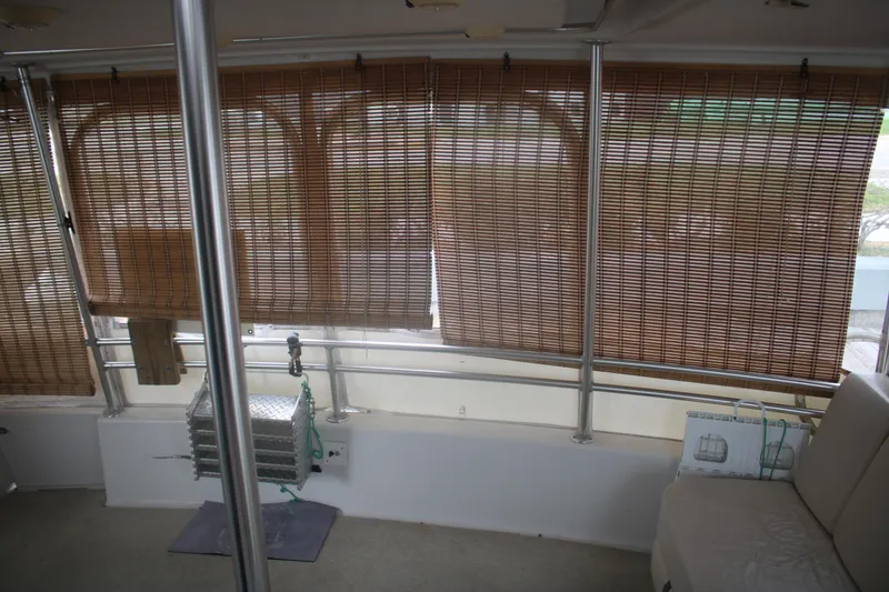 Slide: The Image of 1998 Mainship 47 Motor Yacht interior with bamboo blinds and seating area. - 19