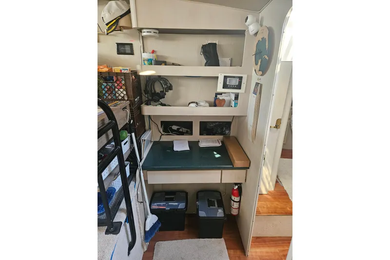 Slide: The Image of 1998 Mainship 47 Motor Yacht interior with organized shelves and workspace. - 21