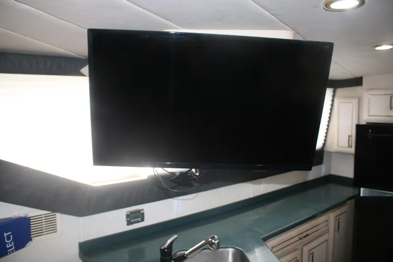 Slide: The Image of Interior of 1998 Mainship 47 Motor Yacht with mounted TV and kitchen sink. - 22