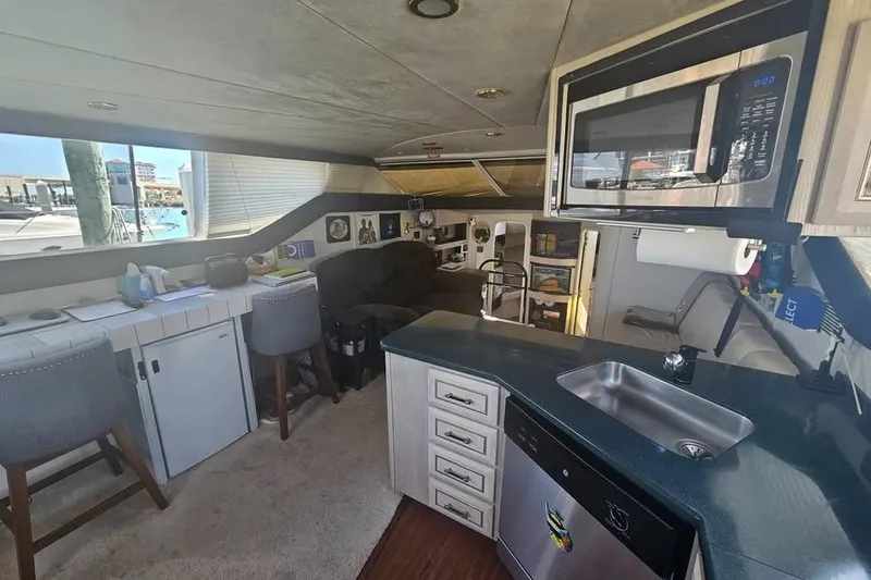 Slide: The Image of Interior of a 1998 Mainship 47 Motor Yacht with modern kitchen and seating area. - 23
