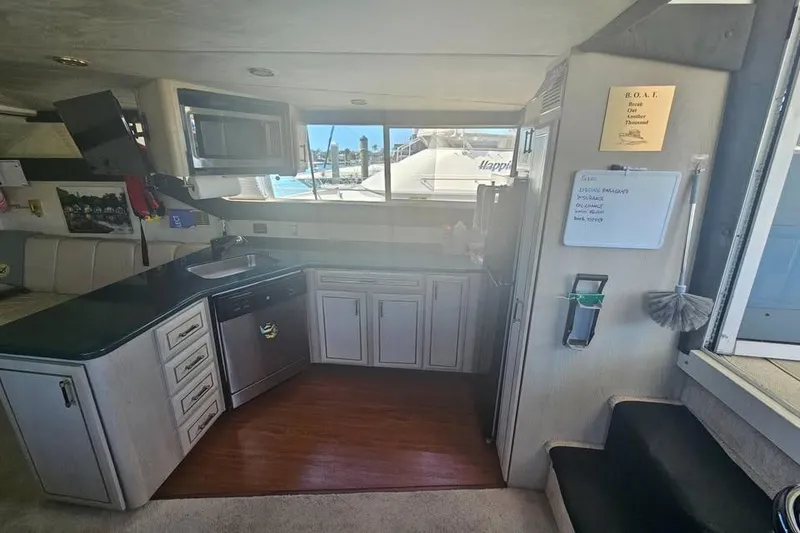 Slide: The Image of Interior of 1998 Mainship 47 Motor Yacht kitchen with modern appliances and window view. - 24