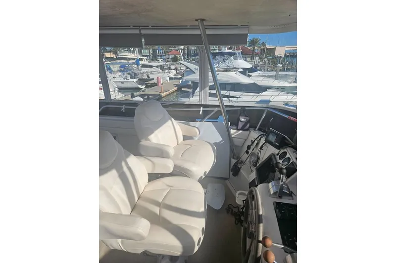 Slide: The Image of Interior view of 1998 Mainship 47 Motor Yacht with helm and seating area. - 25
