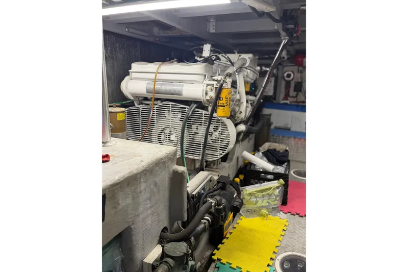 Slide: The Image of Engine room of a 1998 Mainship 47 Motor Yacht, showcasing mechanical components. - 28