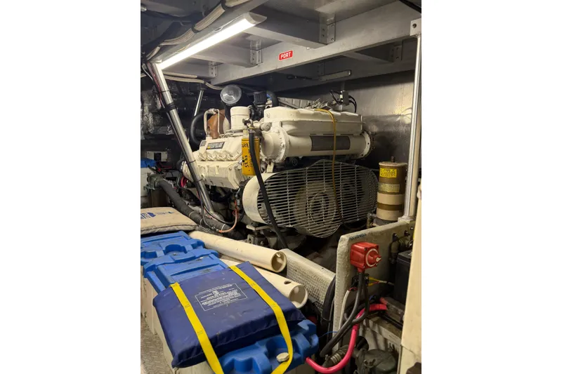 Slide: The Image of Engine room of a 1998 Mainship 47 Motor Yacht, featuring mechanical components and safety equipment. - 29
