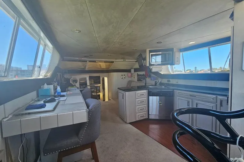 Slide: The Image of Interior of a 1998 Mainship 47 Motor Yacht with modern kitchen and workspace. - 34