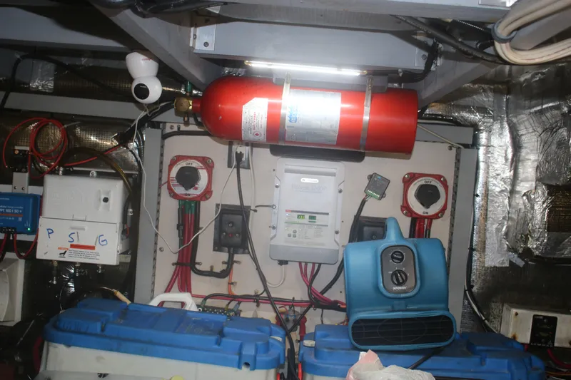 Slide: The Image of Engine room of a 1998 Mainship 47 Motor Yacht with equipment and wiring. - 41