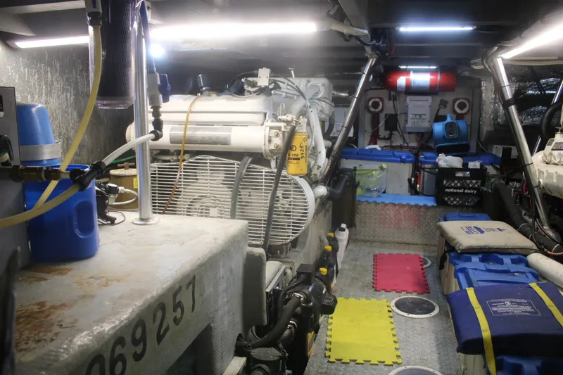 Slide: The Image of Engine room of a 1998 Mainship 47 Motor Yacht, featuring equipment and storage. - 44