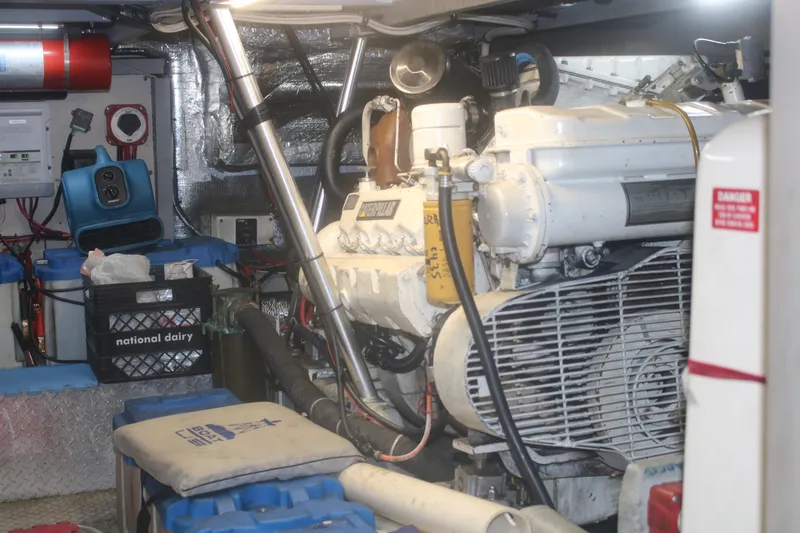 Slide: The Image of Engine room of a 1998 Mainship 47 Motor Yacht, showcasing machinery and equipment. - 48