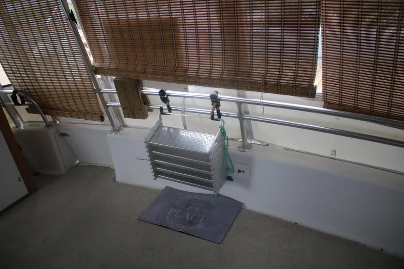 Slide: The Image of Interior of 1998 Mainship 47 Motor Yacht with bamboo blinds and metal railing. - 53