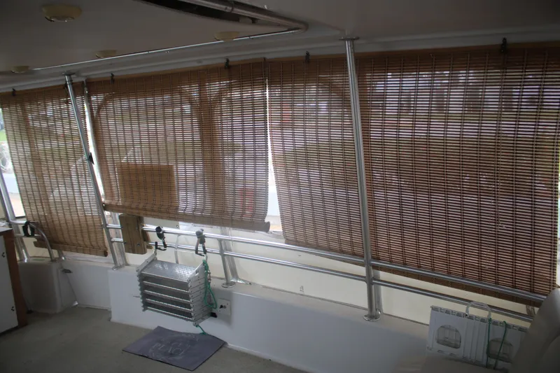 Slide: The Image of Interior of 1998 Mainship 47 Motor Yacht with bamboo blinds and metal railings. - 55