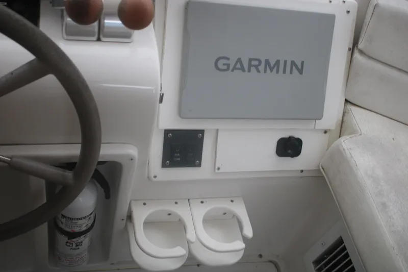 Slide: The Image of Control panel of a 1998 Mainship 47 Motor Yacht with Garmin navigation system. - 58