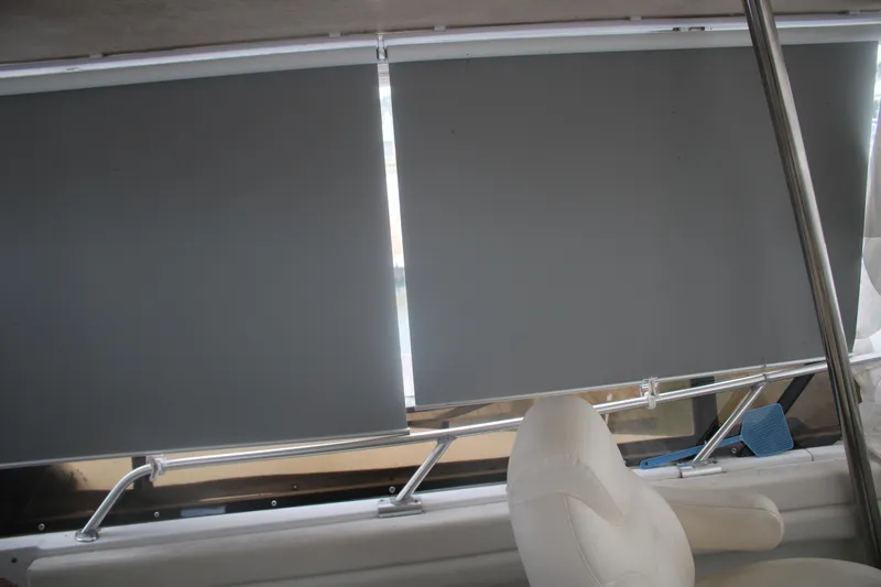 Slide: The Image of Interior of 1998 Mainship 47 Motor Yacht with window blinds and white seating. - 59