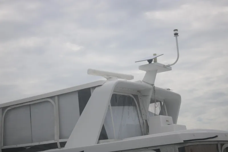 Slide: The Image of 1998 Mainship 47 Motor Yacht with radar equipment against cloudy sky. - 6
