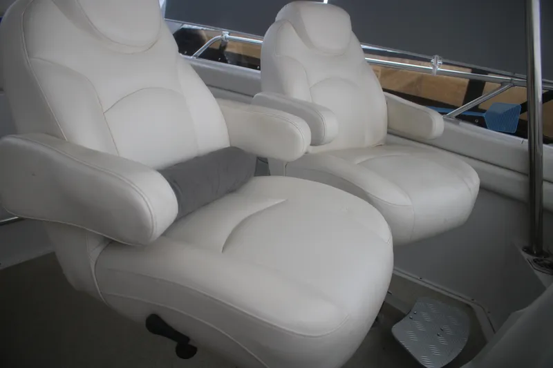 Slide: The Image of Luxurious white seating on 1998 Mainship 47 Motor Yacht, featuring plush armchairs. - 61