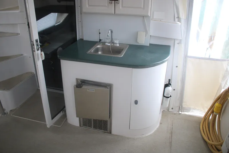 Slide: The Image of 1998 Mainship 47 Motor Yacht interior with compact kitchenette and sink. - 64