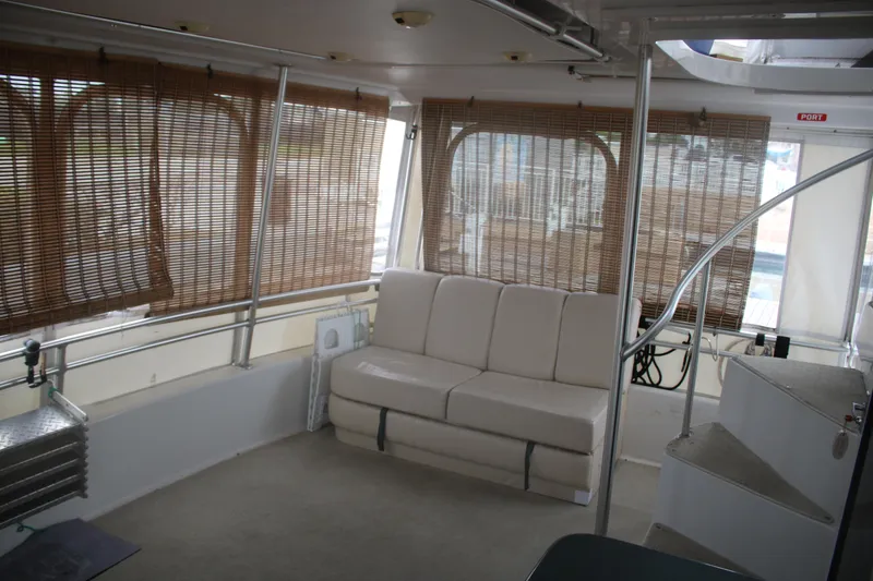 Slide: The Image of Interior of 1998 Mainship 47 Motor Yacht with beige seating and bamboo blinds. - 66