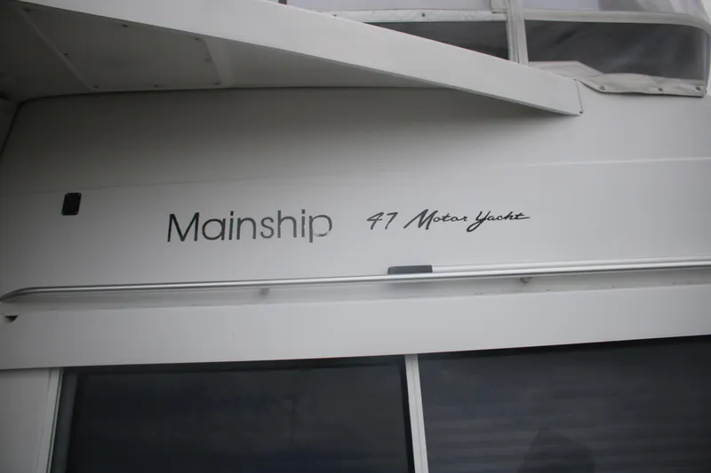 Slide: The Image of 1998 Mainship 47 Motor Yacht exterior with model name displayed. - 8