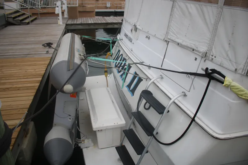 Slide: The Image of 1998 Mainship 47 Motor Yacht docked with inflatable boat attached. - 9