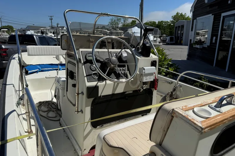 Slide: The Image of 1994 Boston Whaler 17 Montauk boat interior with steering wheel and controls. - 3