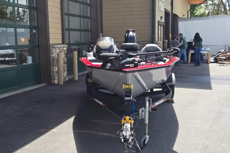 Slide: The Image of 2021 Tracker Pro Team 175 TXW boat on trailer, parked outside a building. - 2