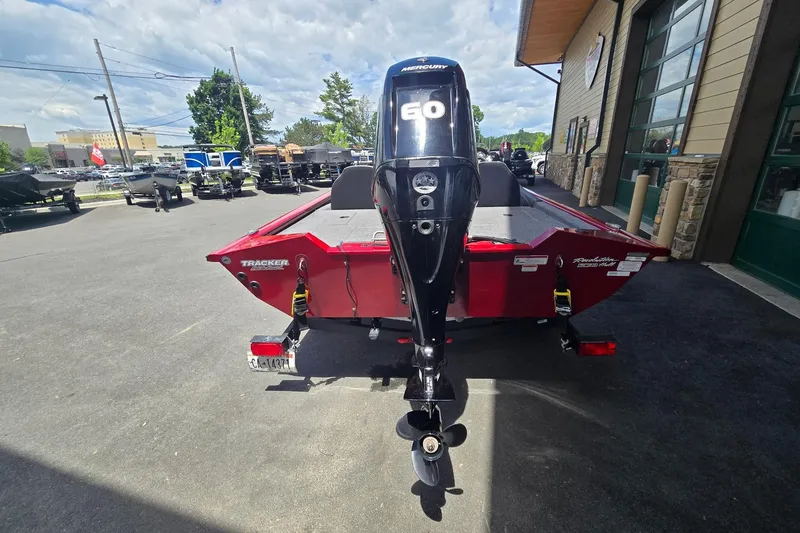 Slide: The Image of 2021 Tracker Pro Team 175 TXW boat with Mercury 60 engine, parked outdoors. - 4