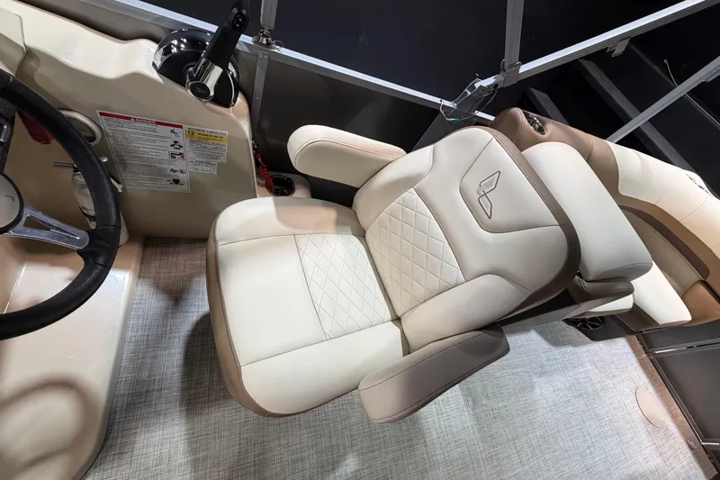 Slide: The Image of 2024 Lowe SS 230 boat interior with luxurious beige captain's chair and steering console. - 13