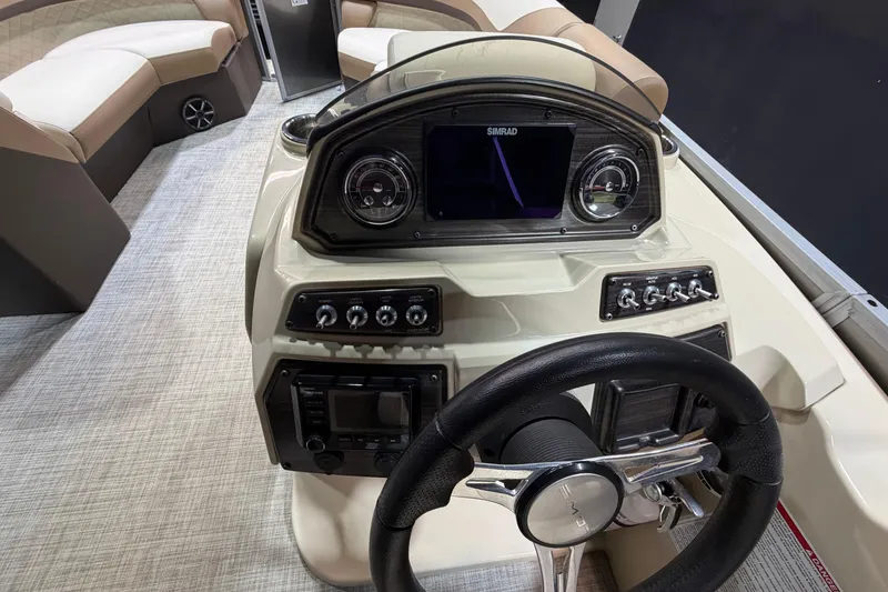 Slide: The Image of 2024 Lowe SS 230 boat dashboard with steering wheel and control panel. - 14