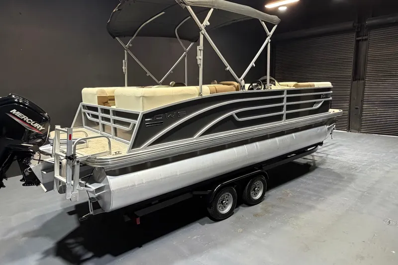 Slide: The Image of 2024 Lowe SS 230 pontoon boat with Mercury engine in a showroom setting. - 4