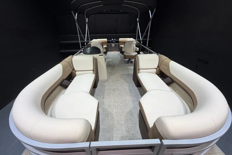 Slide: The Image of 2024 Lowe SS 230 pontoon boat interior with beige seating and helm station. - 6