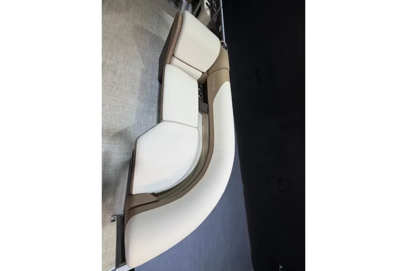Slide: The Image of 2024 Lowe SS 230 boat interior with elegant white and beige seating. - 7