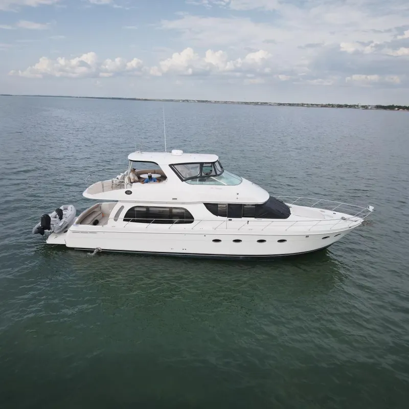 The Image of 2004 Carver 560 Voyager yacht cruising on open water. - 0