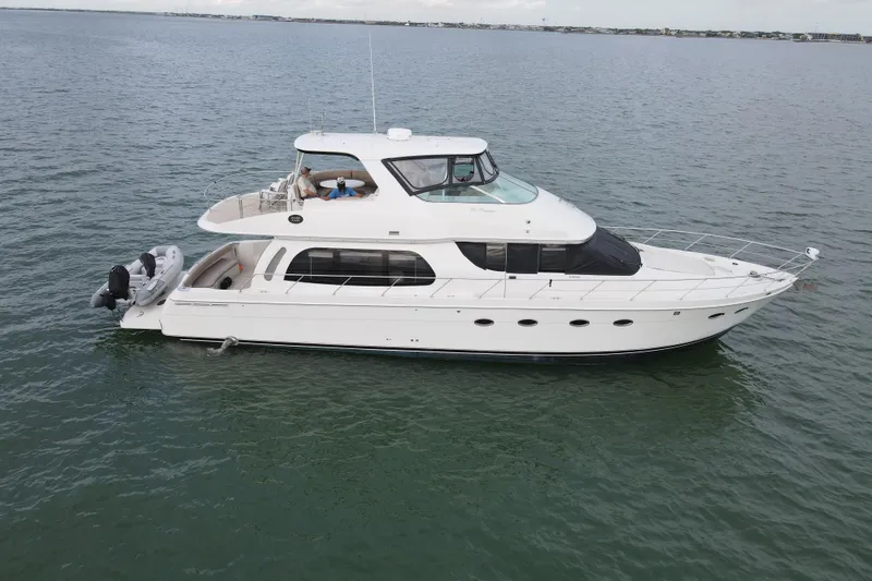 The Image of 2004 Carver 560 Voyager yacht cruising on open water. - 1